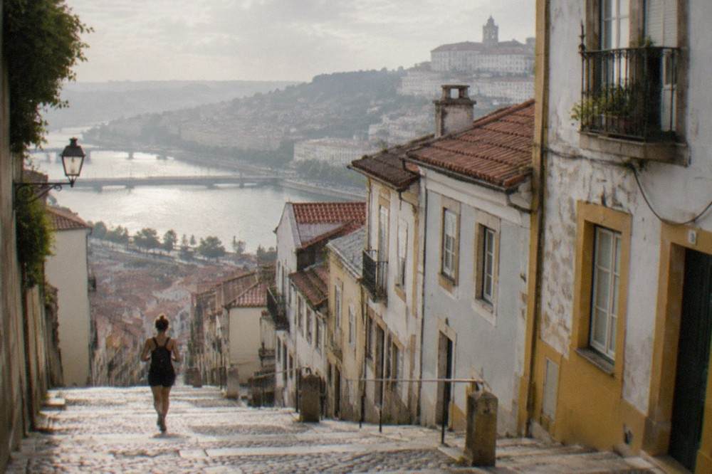 Steep cobbled lane in Coimbra's old town leading down towards the Baixa and the River Mondego