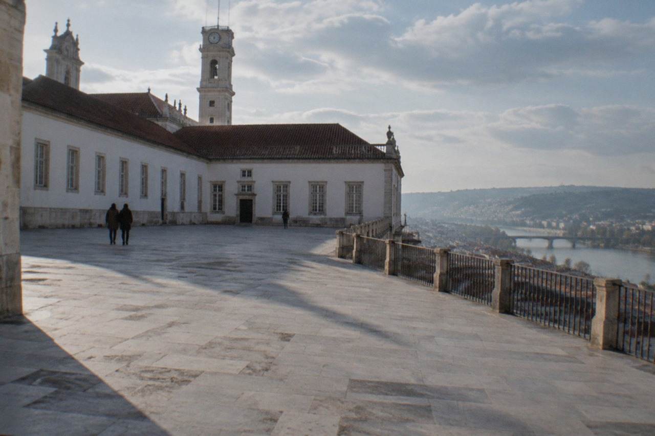 The University of Coimbra's Paço das Escolas courtyard seen from the old town hillside on a bright morning
