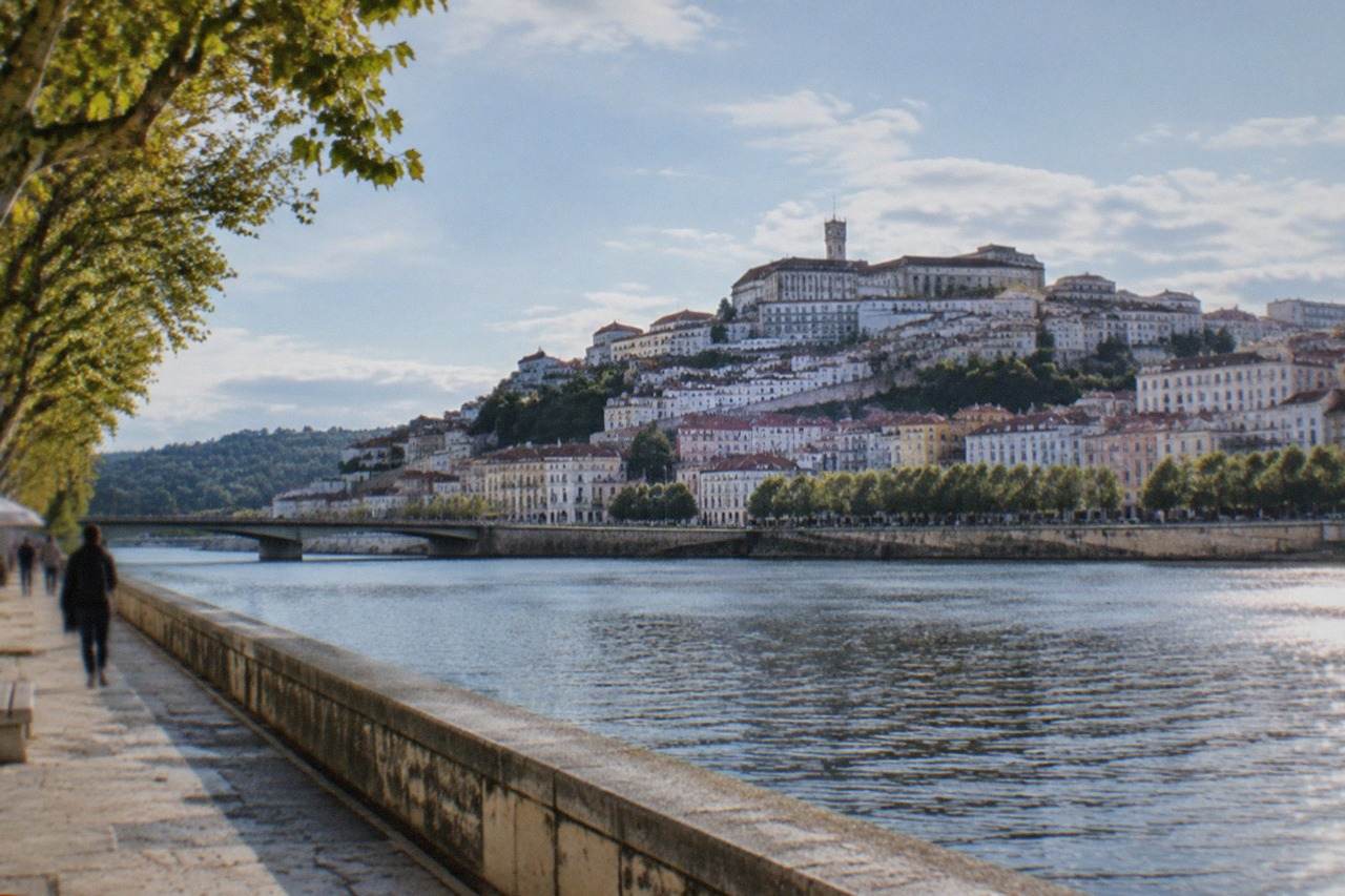 The old university hill of Coimbra seen from across the River Mondego on a bright morning