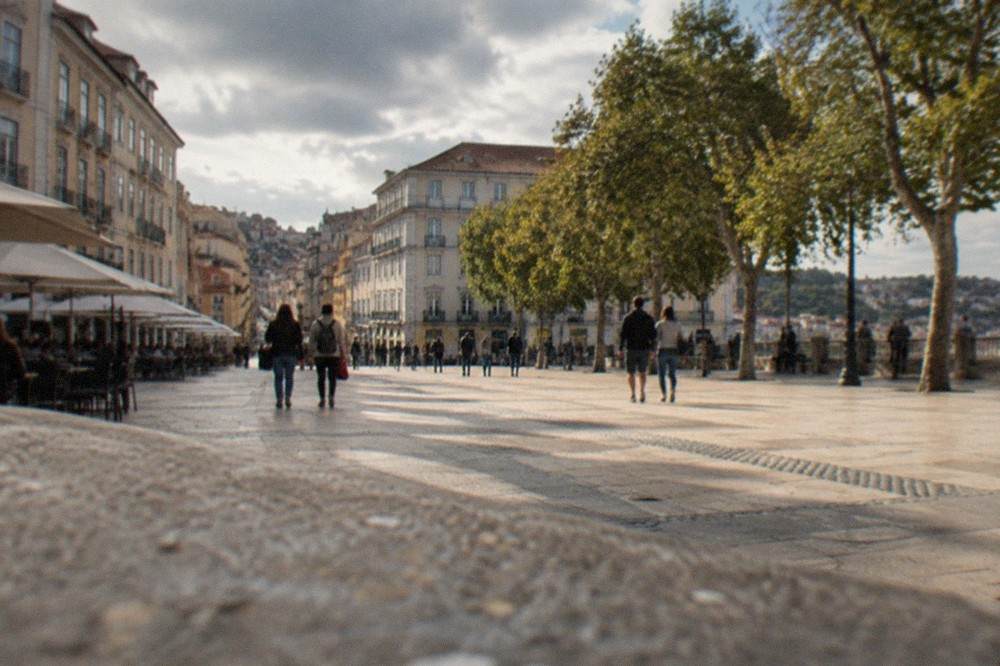 Visitors walking through the narrow old streets below the university hill in Coimbra