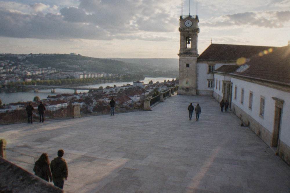 The baroque tower and terrace of the University of Coimbra seen from the old town below