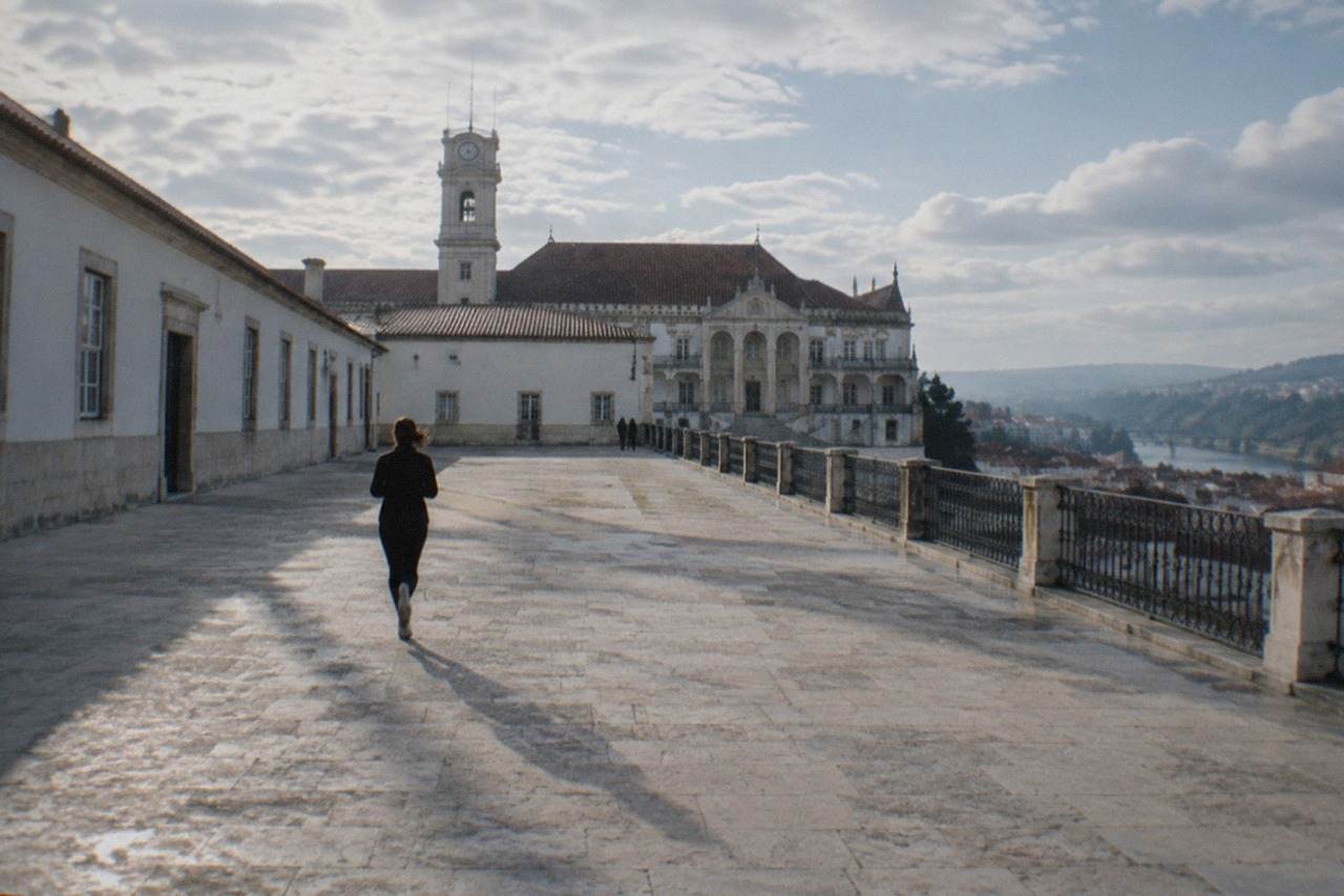 The Paço das Escolas of the University of Coimbra seen from the old town rooftops on a bright morning