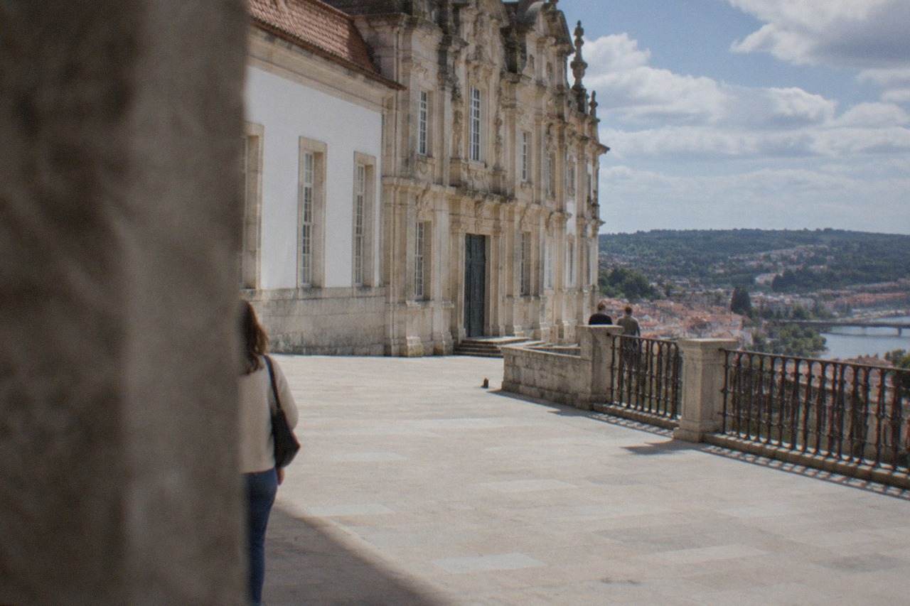 The grand baroque facade of the University of Coimbra's Royal Palace buildings on the hill above the city