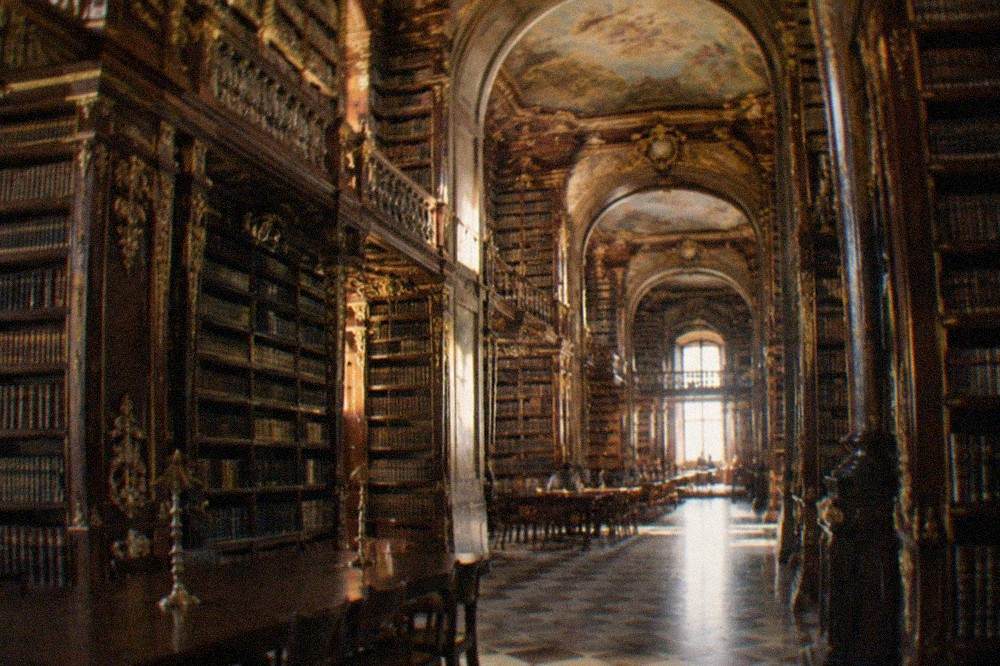 The baroque interior of the Joanina Library with its gilded bookshelves and painted ceiling