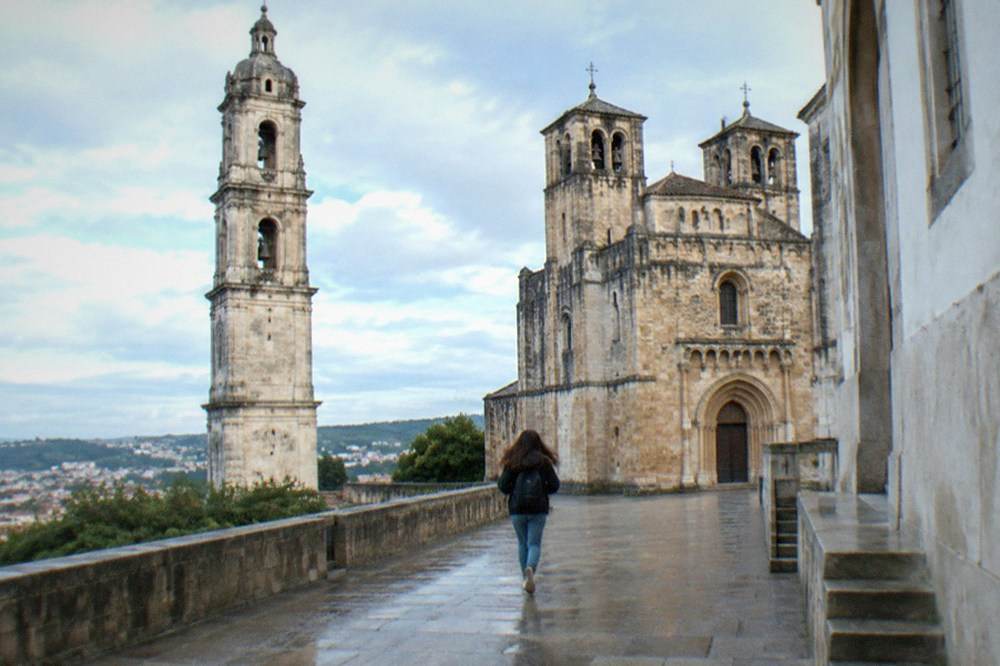 The Romanesque facade and bell towers of the old cathedral of Coimbra in daylight