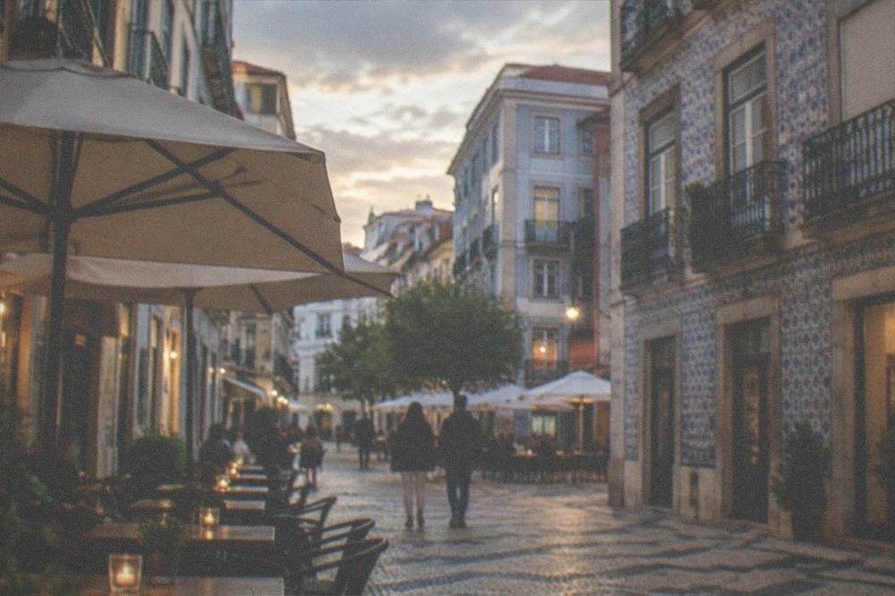 Evening light on a restaurant-lined square in the lower town of Coimbra