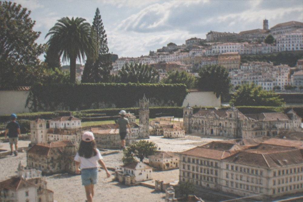 Children walking among small miniature buildings of Portuguese houses and monuments in a park