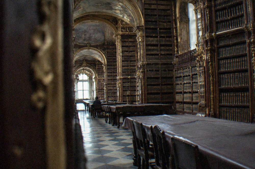 A covered reading table in the Joanina Library with leather cloths protecting the wood