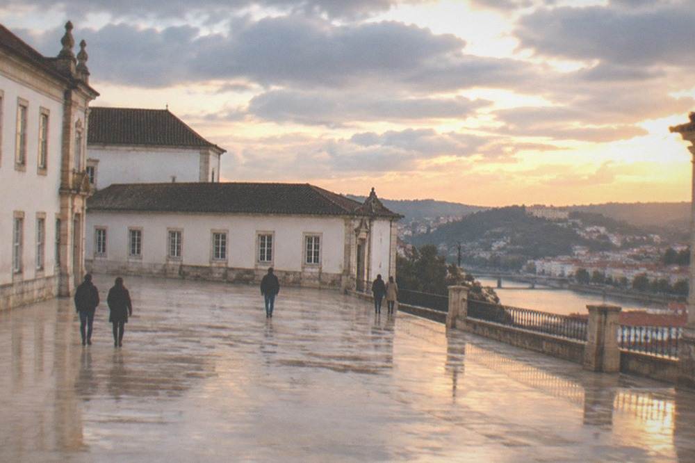 The courtyard of the Paço das Escolas in Coimbra with the university buildings in warm evening light