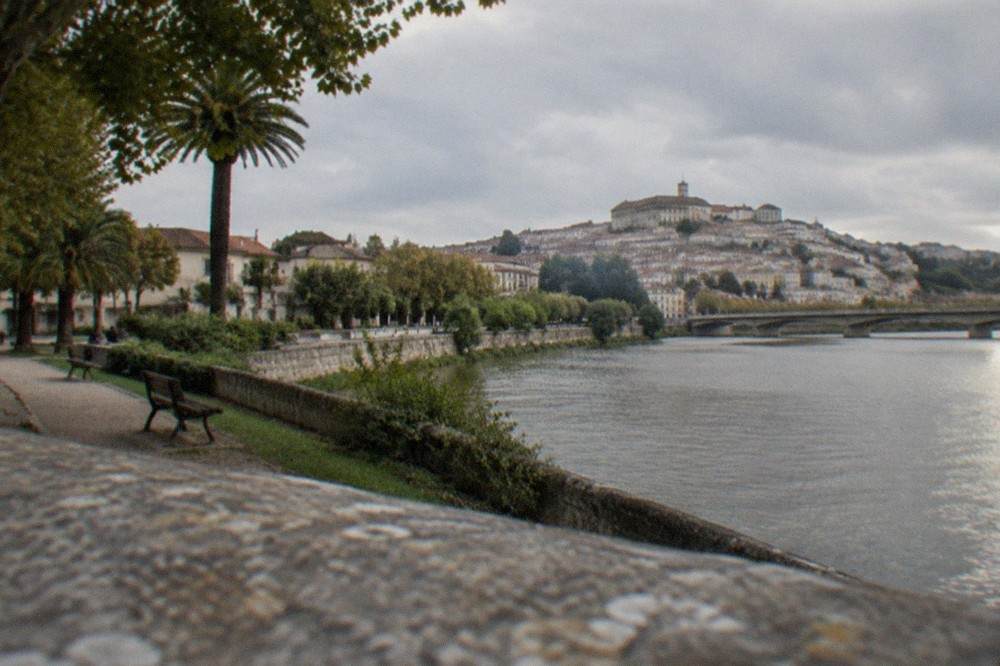 Benches and shaded paths in a small garden terrace above the river on Coimbra's left bank