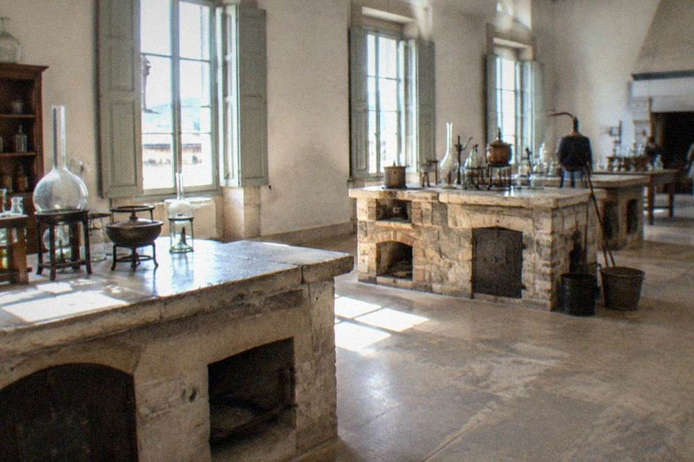 Eighteenth-century chemistry laboratory with stone benches, furnaces and old glass vessels
