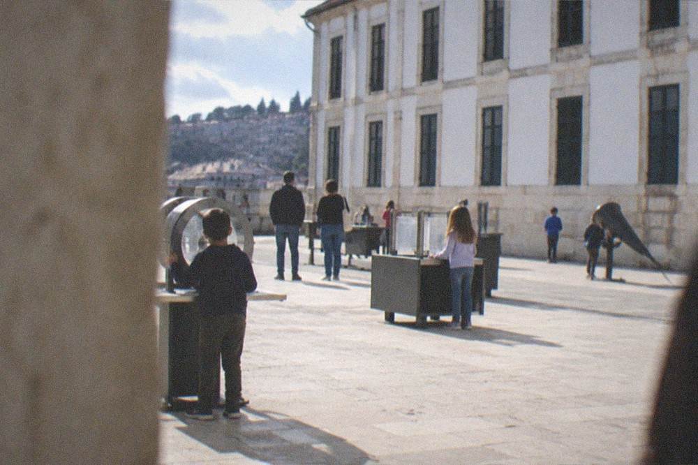 Children and adults looking at interactive science exhibits in a bright museum space