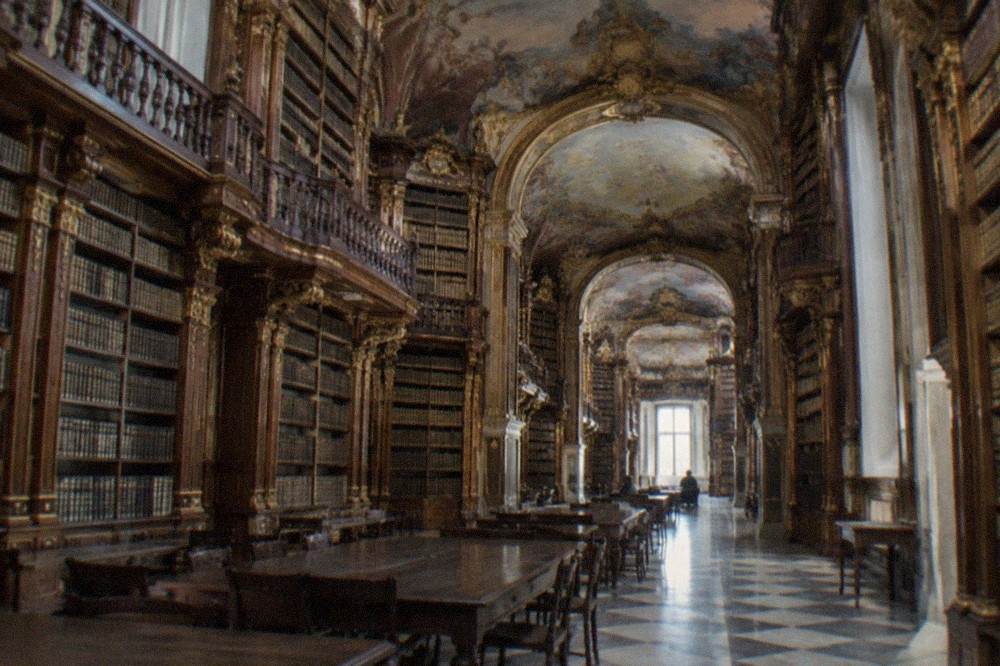 The painted baroque interior of the Joanina Library with its gilded bookshelves