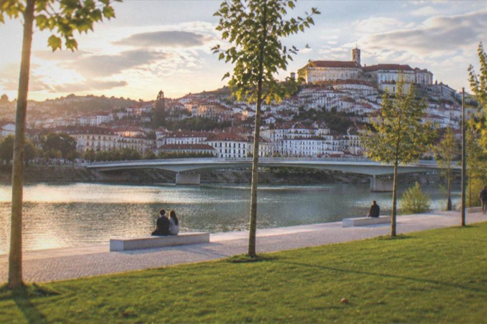 Evening light on the university buildings above the Mondego river and the old town rooftops