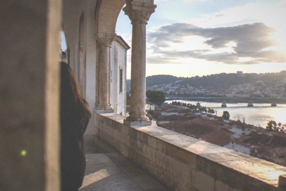 The stone terrace of the Machado de Castro museum overlooking the rooftops and river of central Coimbra