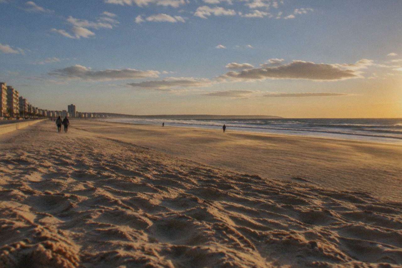 Wide sandy beach with Atlantic waves breaking under a clear blue sky near Figueira da Foz