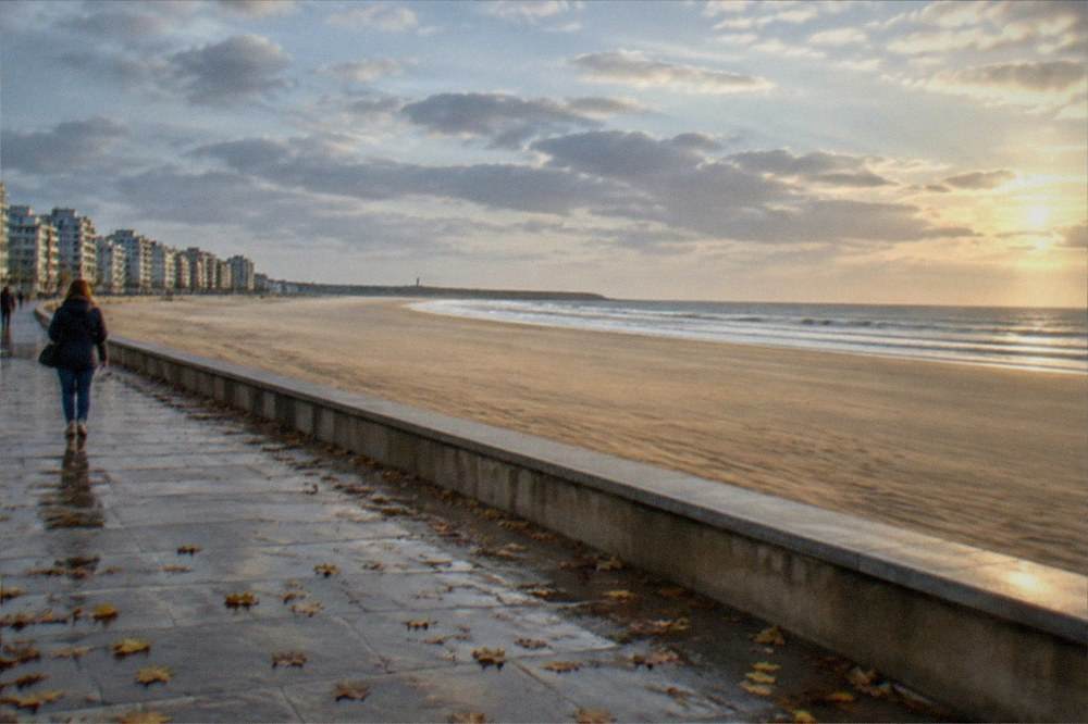 Empty golden beach in late September with calm Atlantic surf and warm evening light