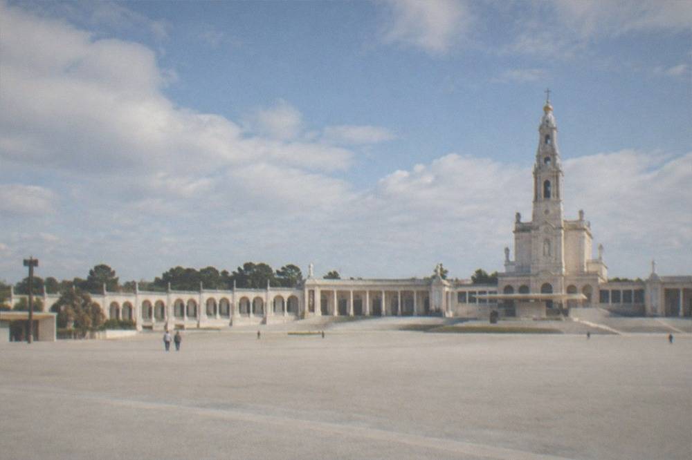 The stone facade of the Fátima basilica seen from the esplanade