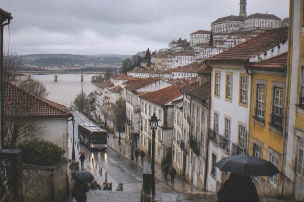 A city bus on a rain-washed street in central Coimbra in winter