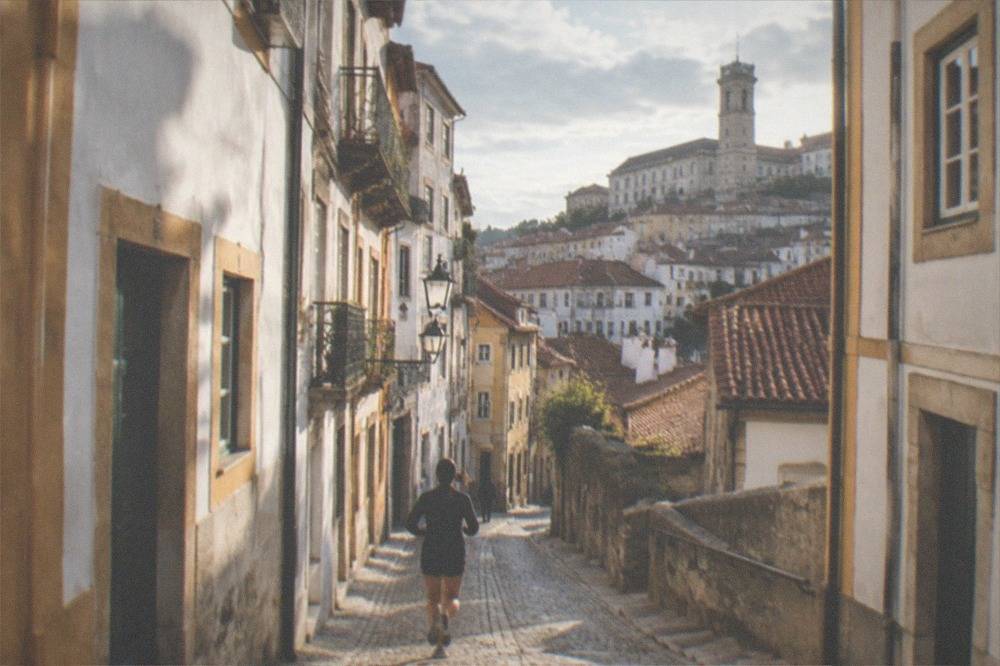A narrow cobbled street in the old town of Coimbra climbing toward the university hill.