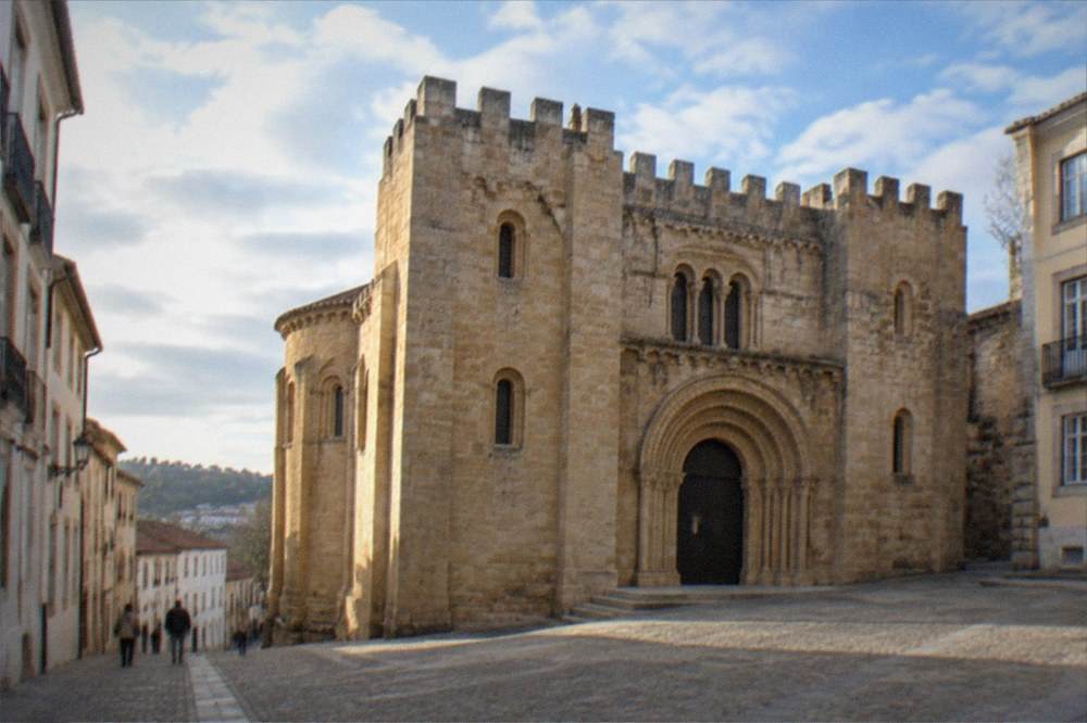The Romanesque doorway of the Sé Velha, the old cathedral of Coimbra, in daylight.