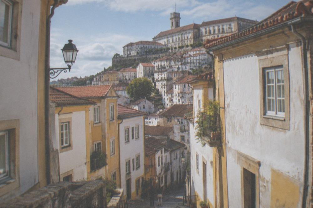 Sunlit university buildings above the old town in warm weather