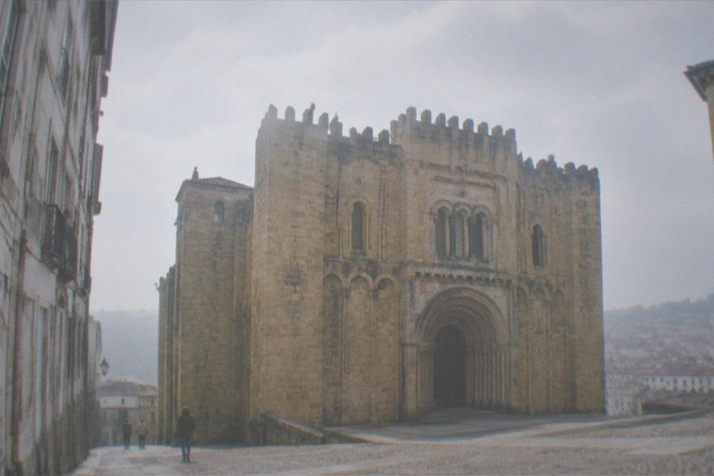 The Romanesque façade of the old cathedral of Coimbra seen from its small square.
