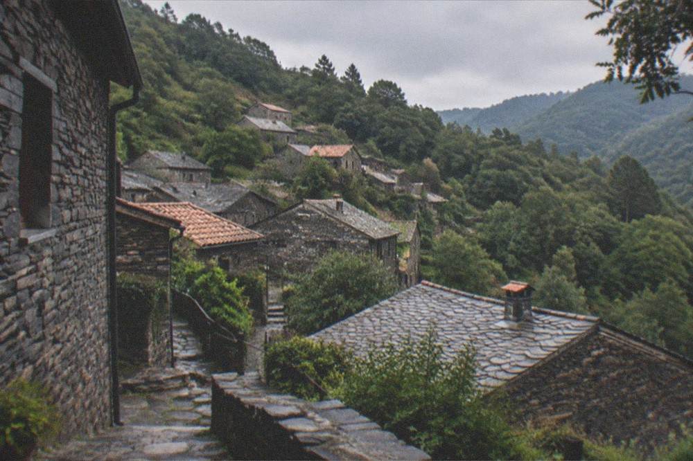 Stone schist village houses with slate walls on a forested mountainside near Lousã.