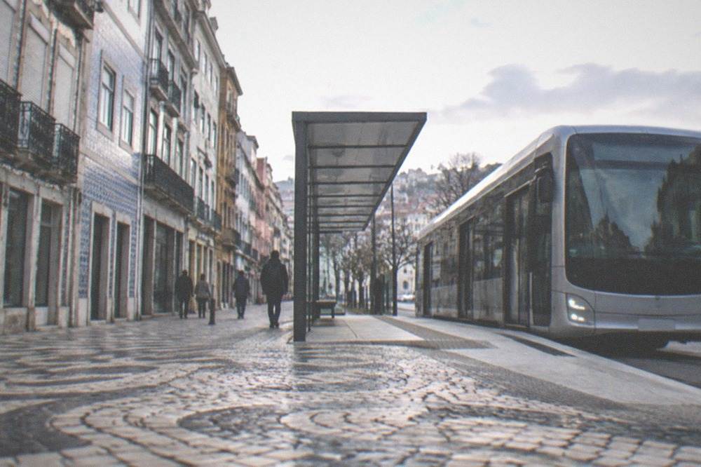 A modern bus rapid transit vehicle at a station platform in Coimbra