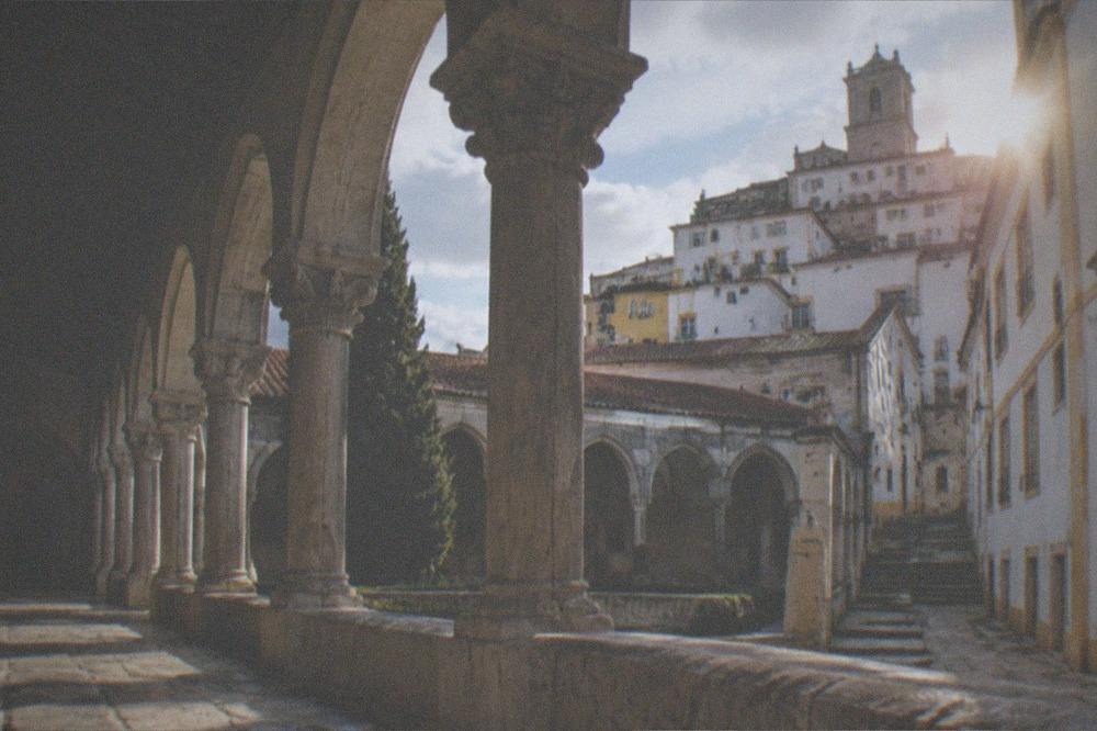 Cloister arches of a Coimbra monastery with afternoon light