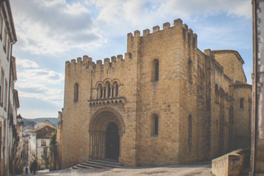 The Romanesque facade of the Sé Velha old cathedral of Coimbra in warm afternoon light