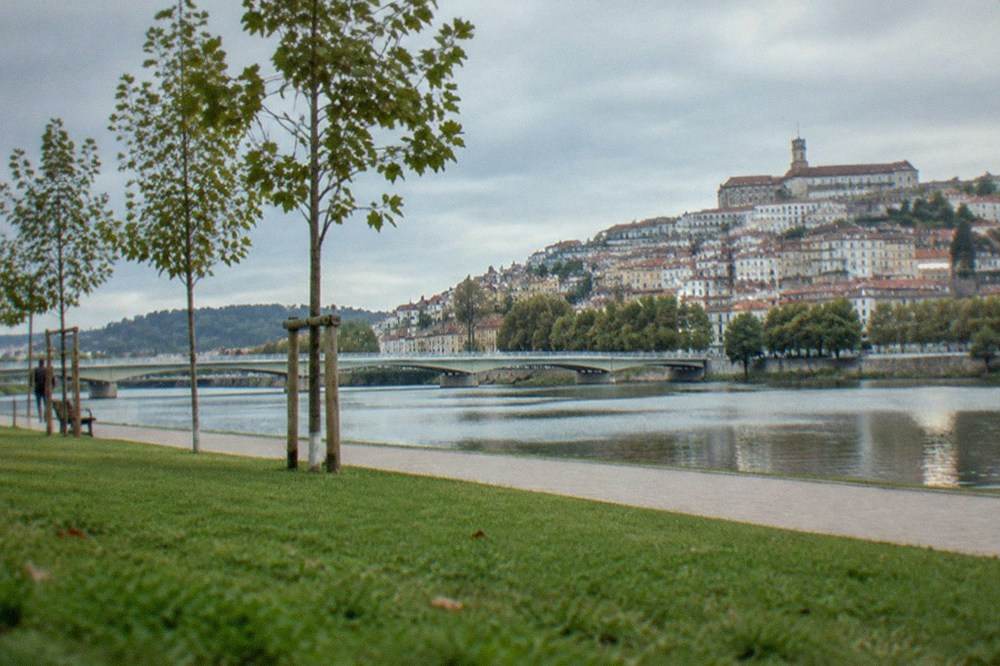 The low town of Coimbra with the Mondego riverbank and the Santa Clara side beyond