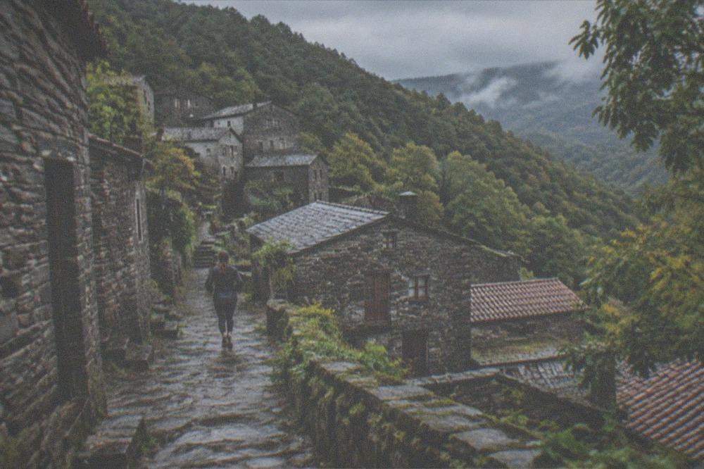 Stone schist village houses on a forested mountain slope near Lousã