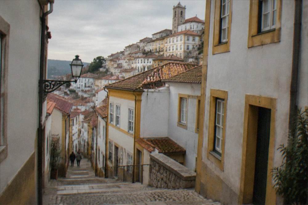 Narrow steep street in Coimbra's old town in warm afternoon light