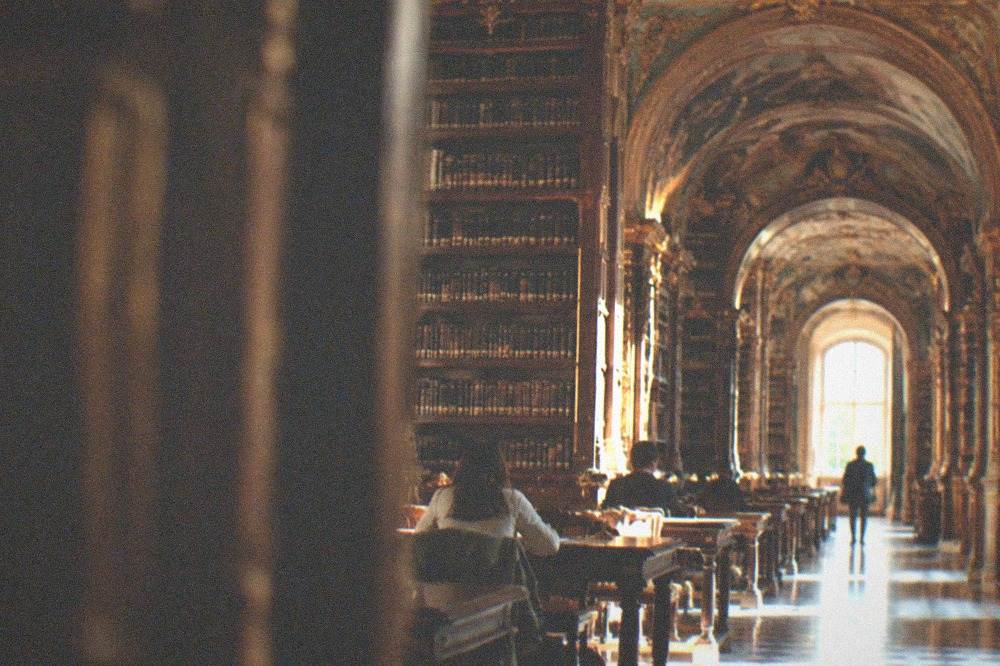 The baroque interior of the Joanina Library in Coimbra with its gilded bookshelves