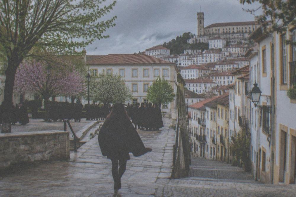Students in black capes gathered in a Coimbra square during the May festival