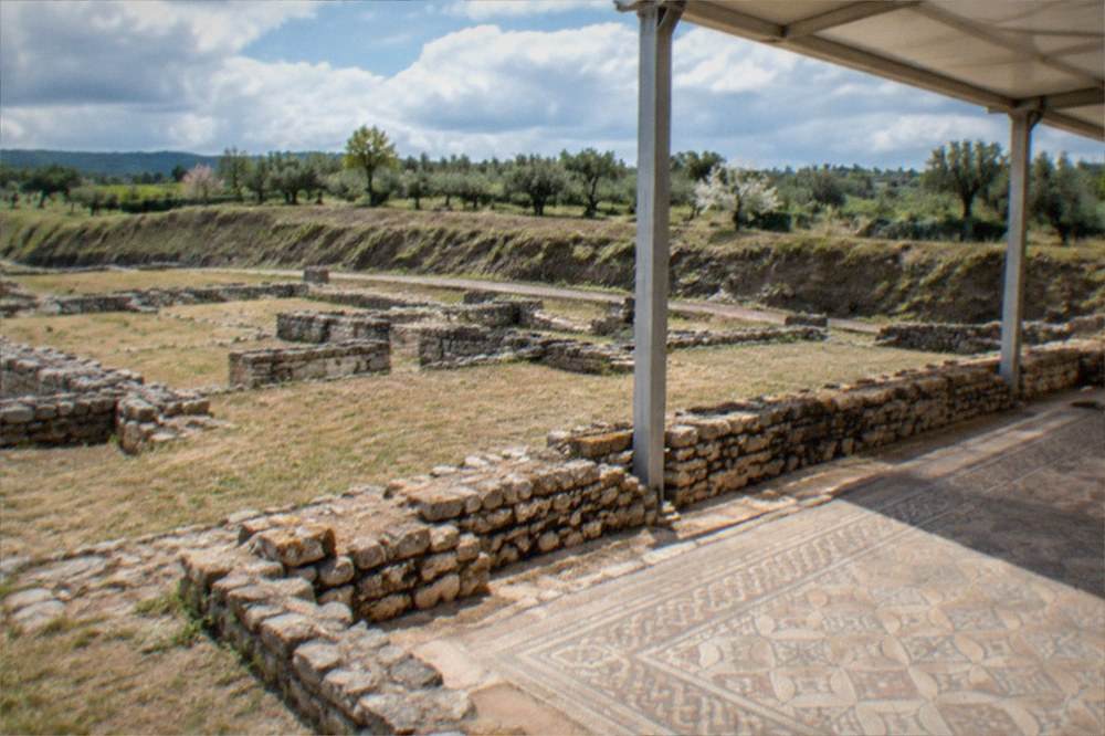 Roman mosaic floors at the Conimbriga ruins under a spring sky