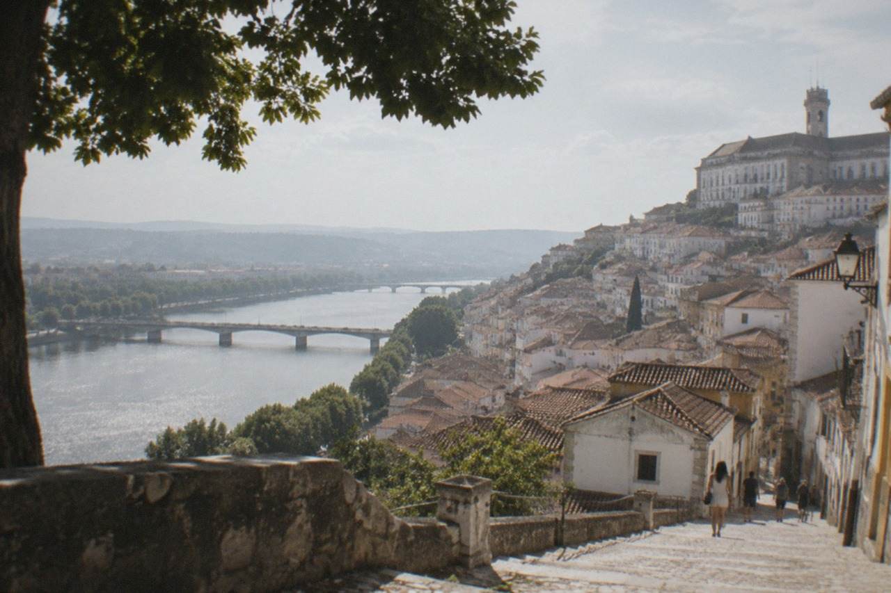 Coimbra's old town seen from the university hill on a bright summer day, with the River Mondego below