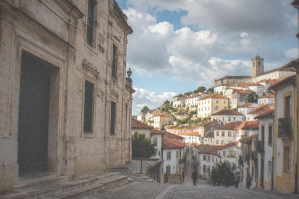 Stone facade of a closed museum building in Coimbra with shuttered entrance