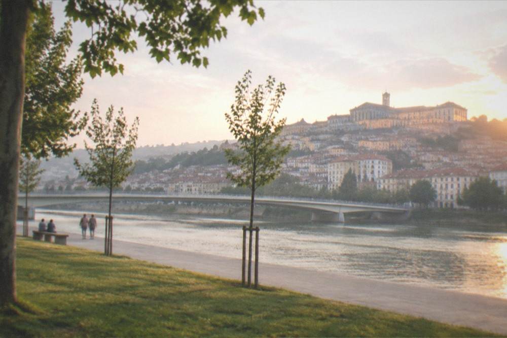 Sunset light on the university buildings with the River Mondego winding through Coimbra below