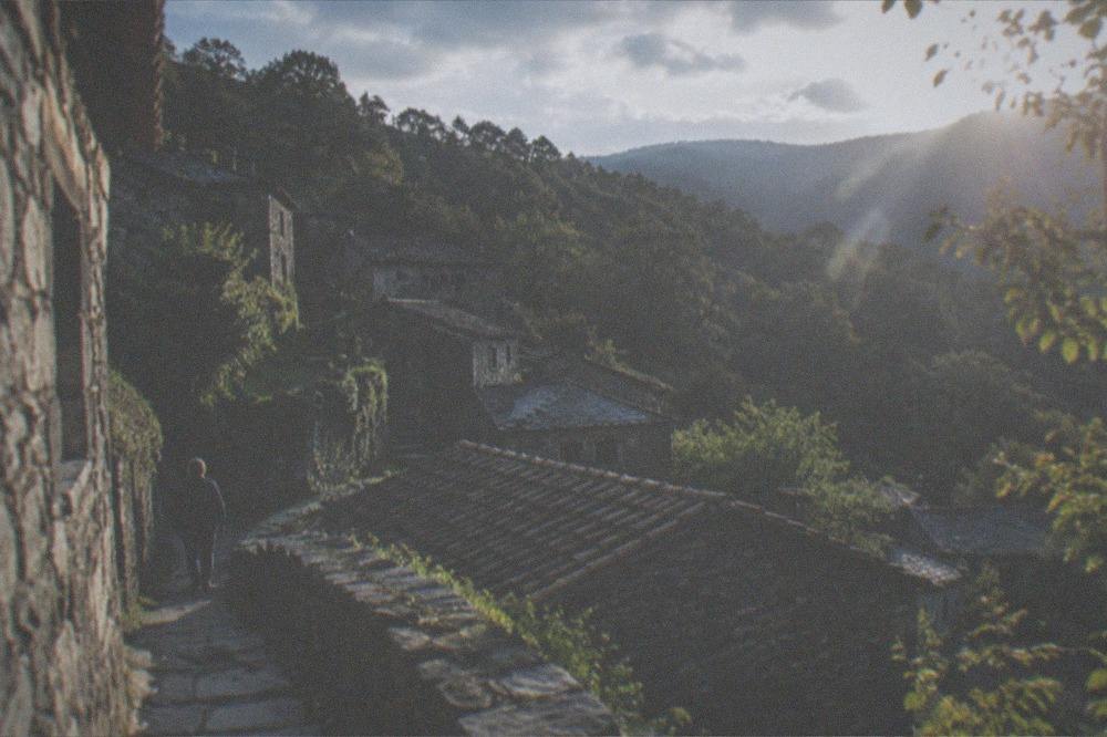 Stone schist village houses on a forested mountainside in the Lousa mountain
