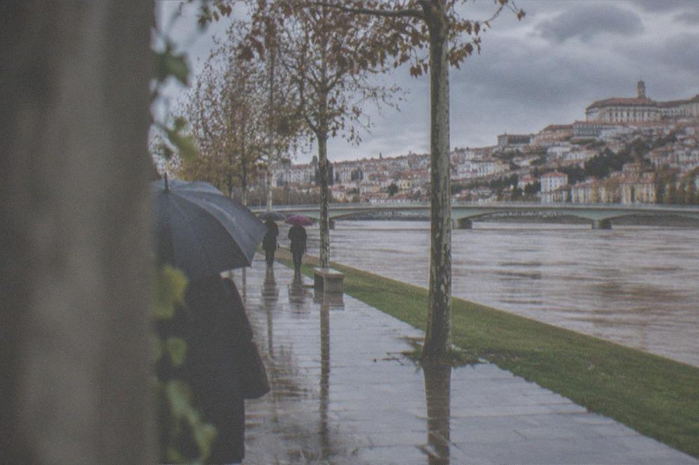 The Mondego riverfront in Coimbra on a mild winter day with the old town behind