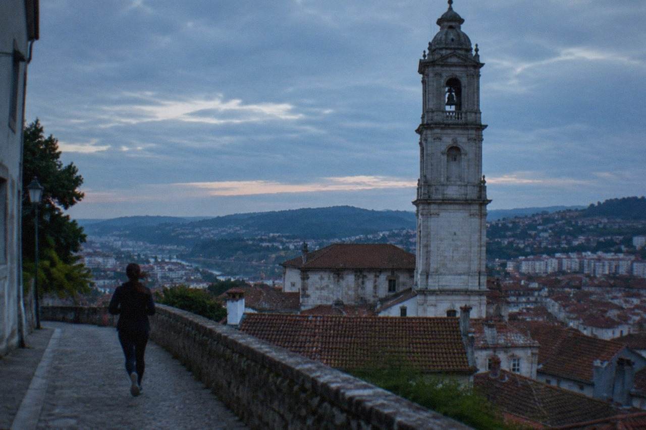 Panorama of Coimbra old town with the Mondego river in the foreground