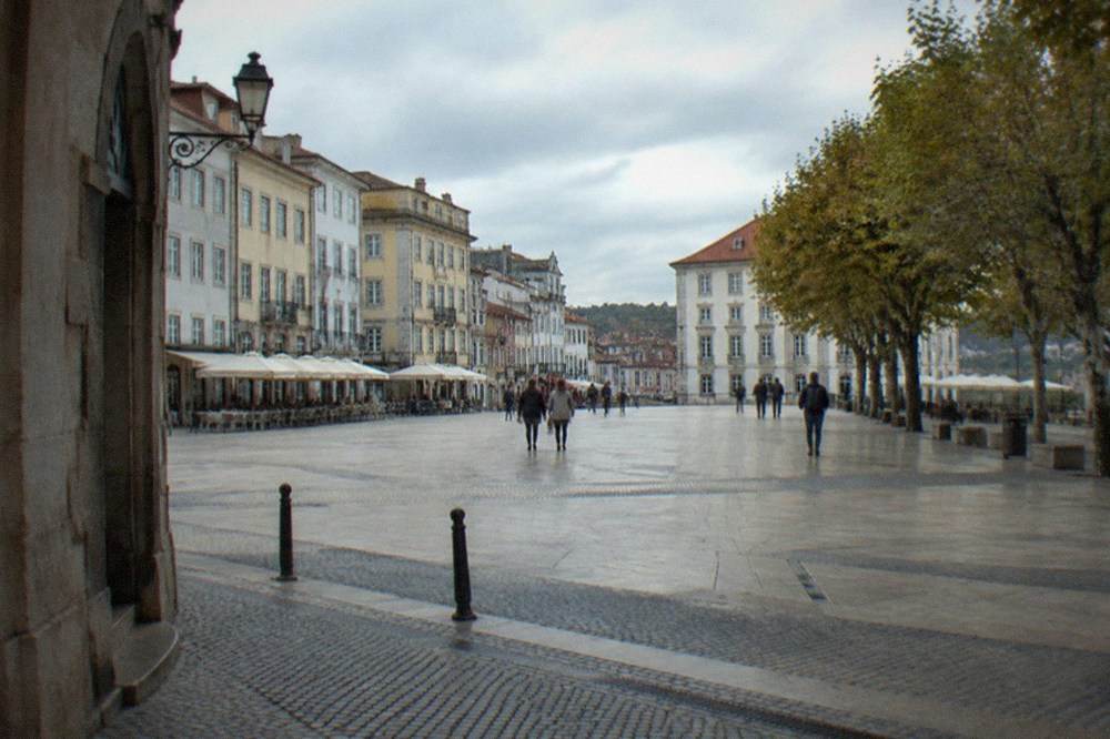 Stone archway and lane on the university hill in Coimbra with old buildings