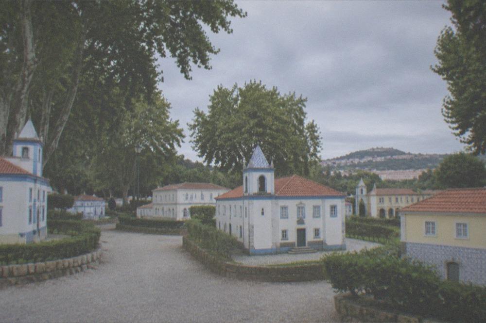 Miniature buildings of Portugal dos Pequenitos seen from a path