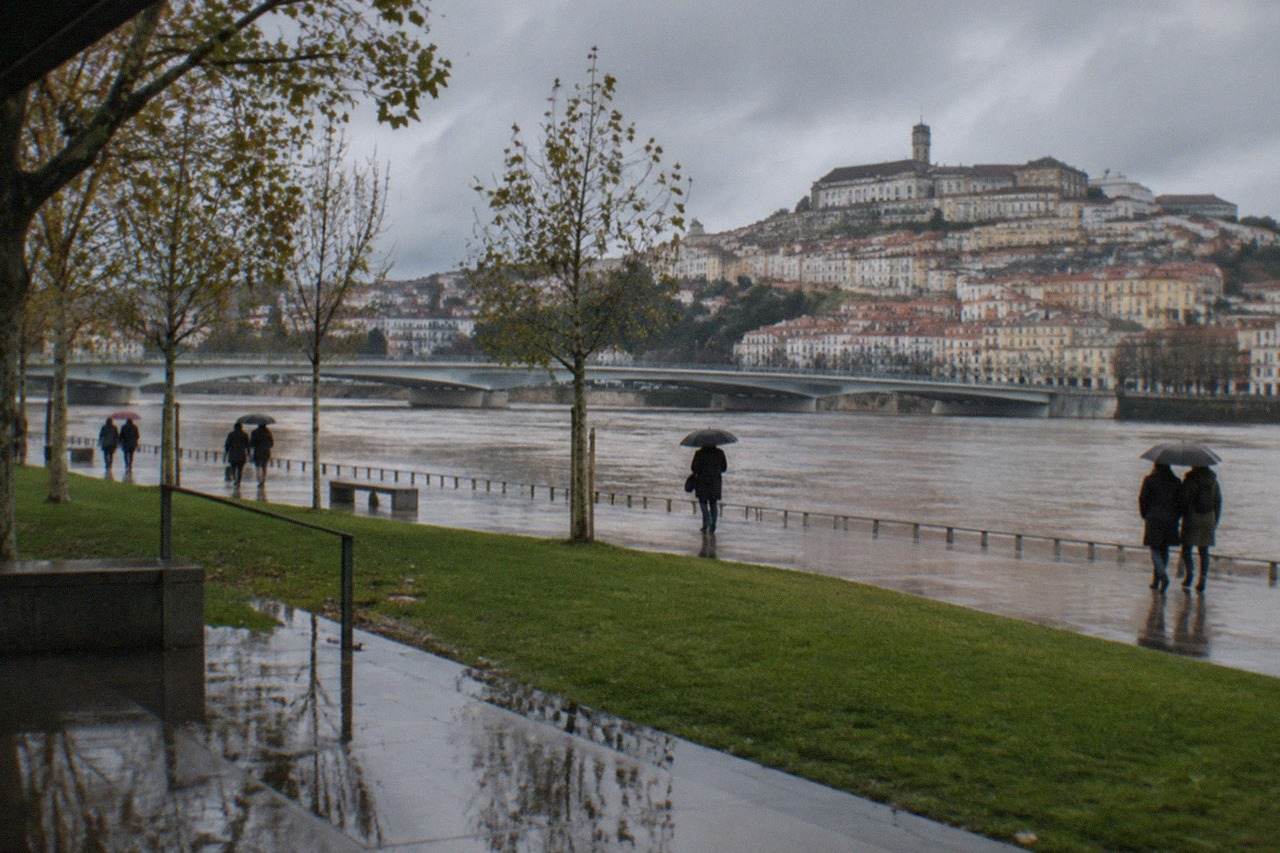 The old university buildings of Coimbra seen across the River Mondego on a calm winter morning
