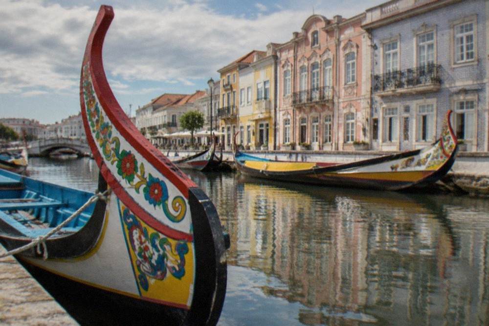 Colourful moliceiro boats moored along an Aveiro canal