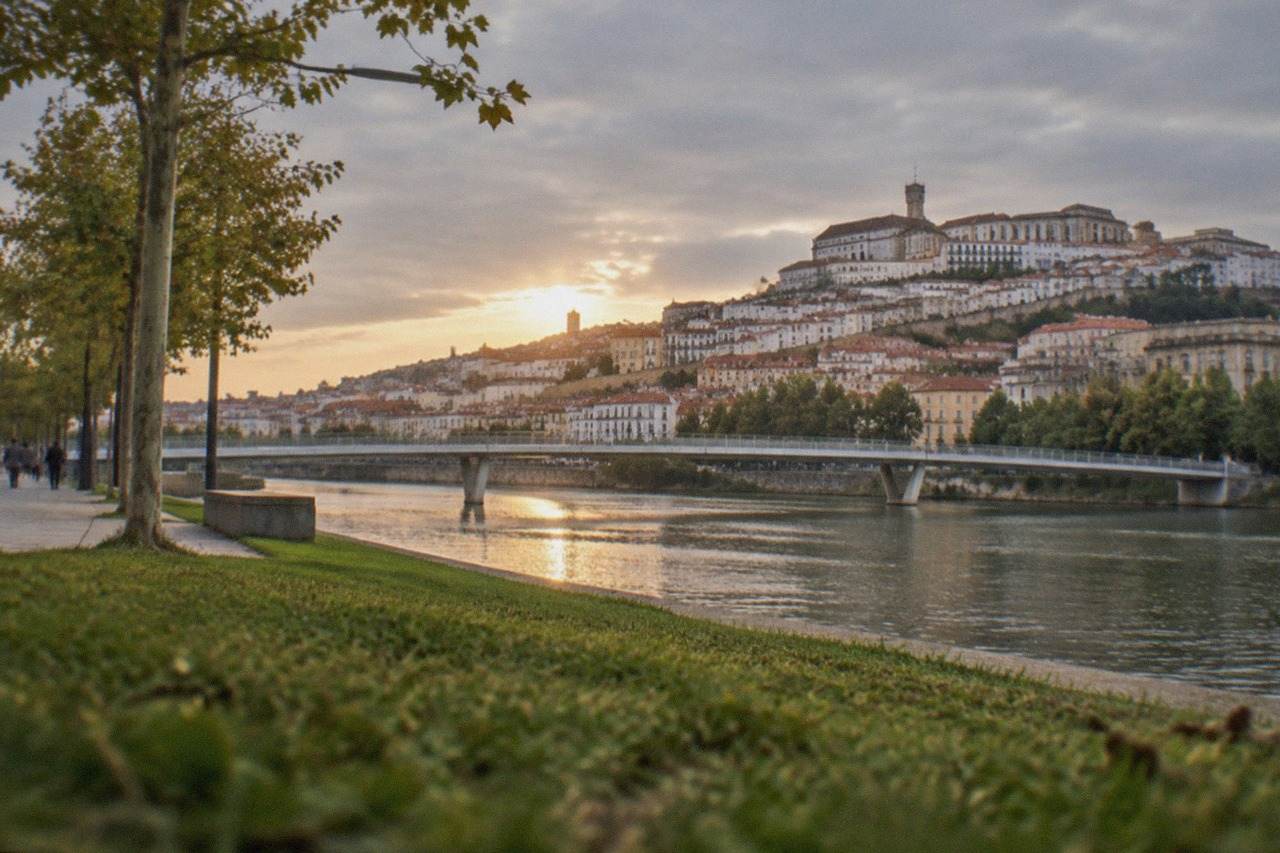 The historic university hill of Coimbra rising above the River Mondego at golden hour