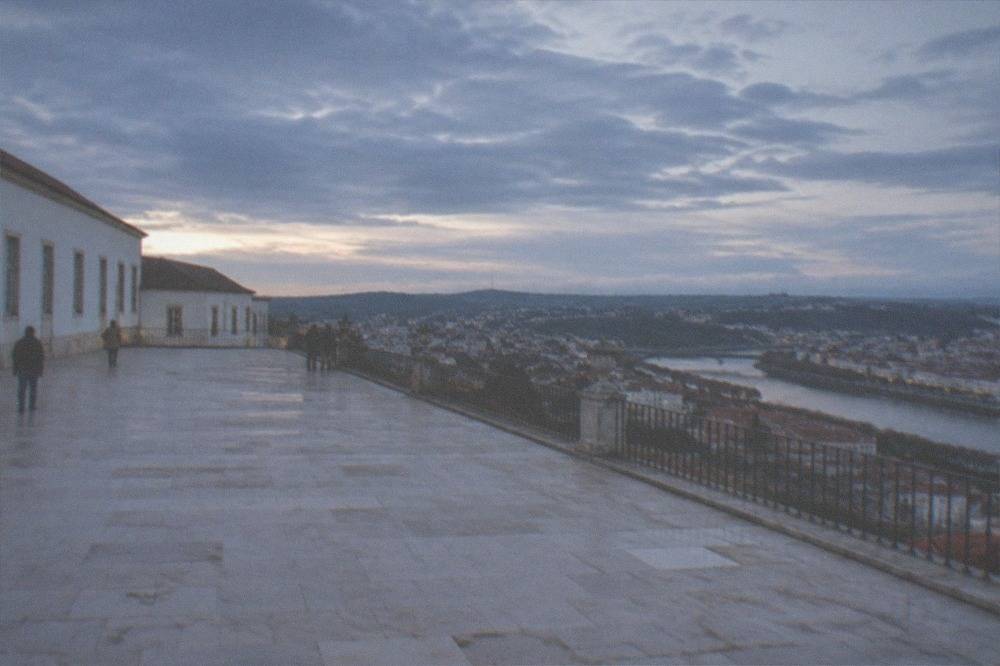 The white facade and terrace of the Royal Palace at the University of Coimbra overlooking the city