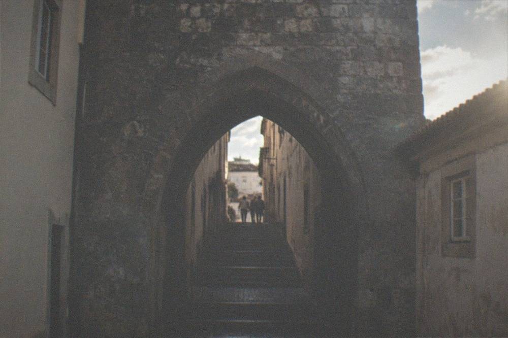 The Arco de Almedina medieval gate leading downhill into the lower old town of Coimbra